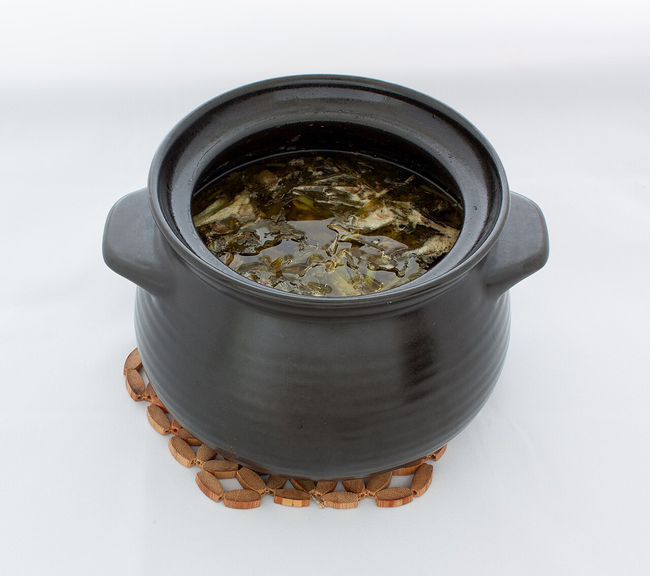 Dizi (ābgusht) — the bazaar lunch eaten in two stages with a wooden pestle.