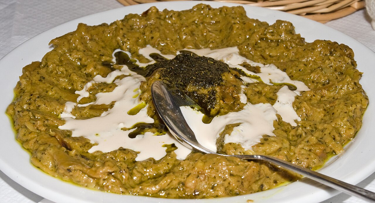 Kashk‑e bademjan — roasted aubergine with kashk, walnut and fried mint.