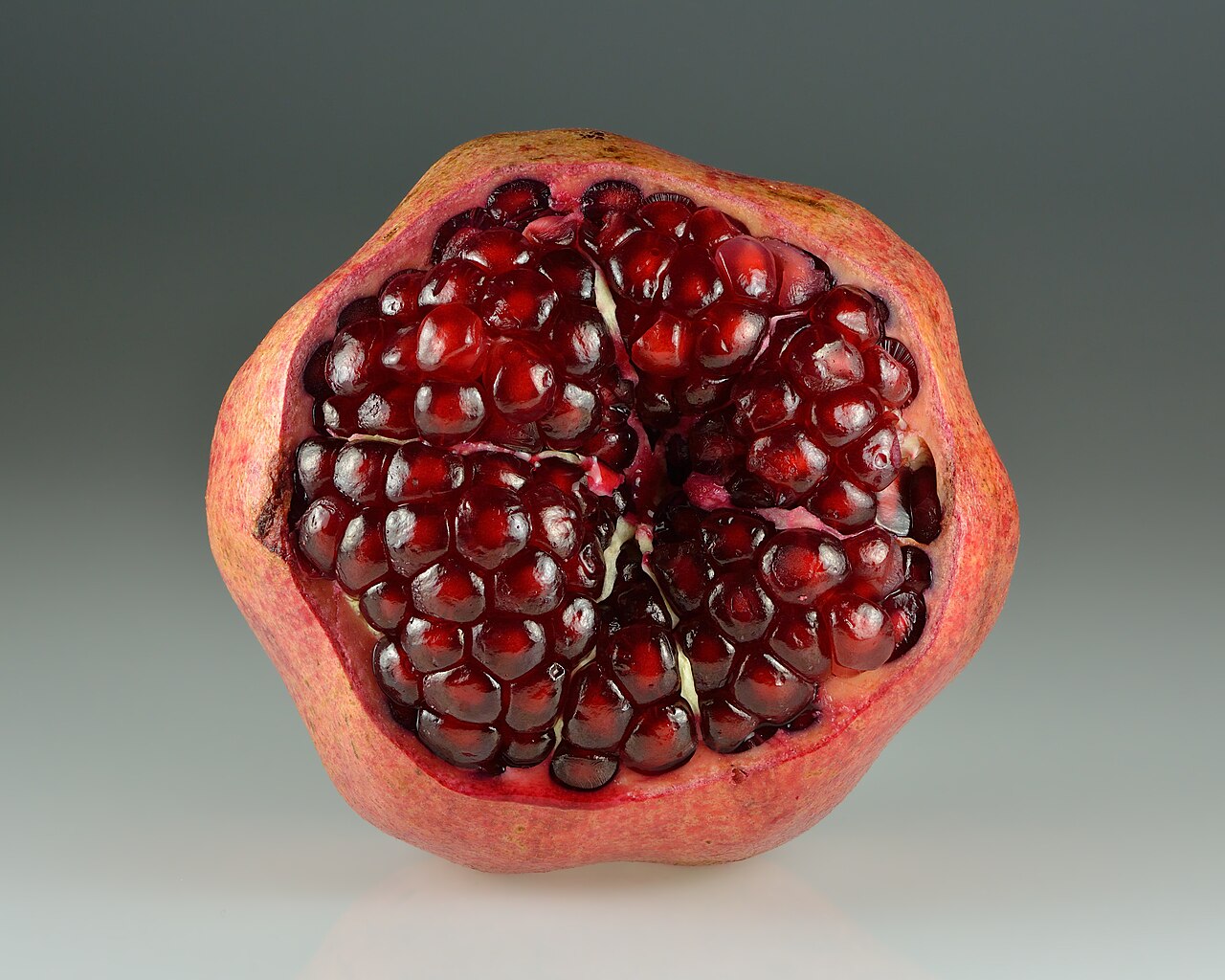 Pomegranate — native to the Iranian plateau and central to fesenjān and Yalda night.