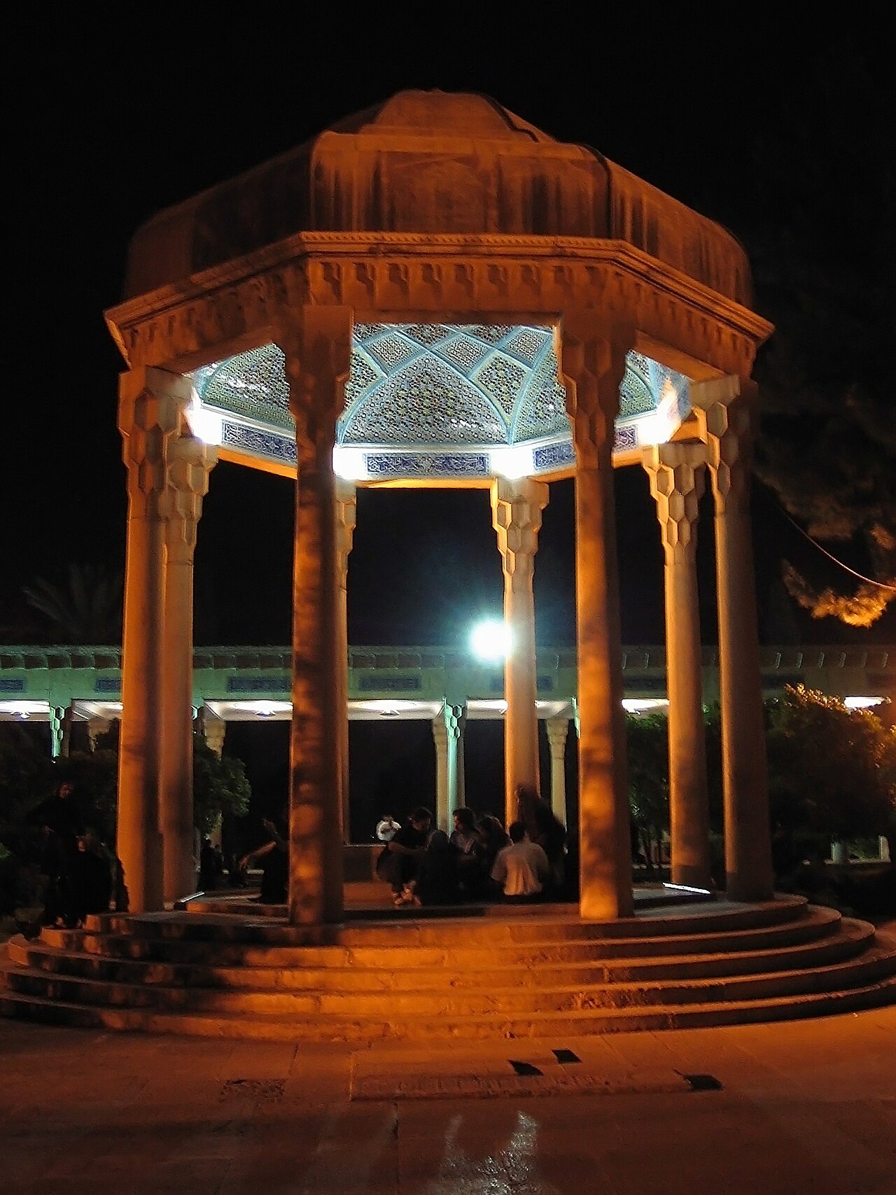 The Hafezieh in Shiraz illuminated after dark — pilgrims read ghazals aloud until midnight on Hafez Day.