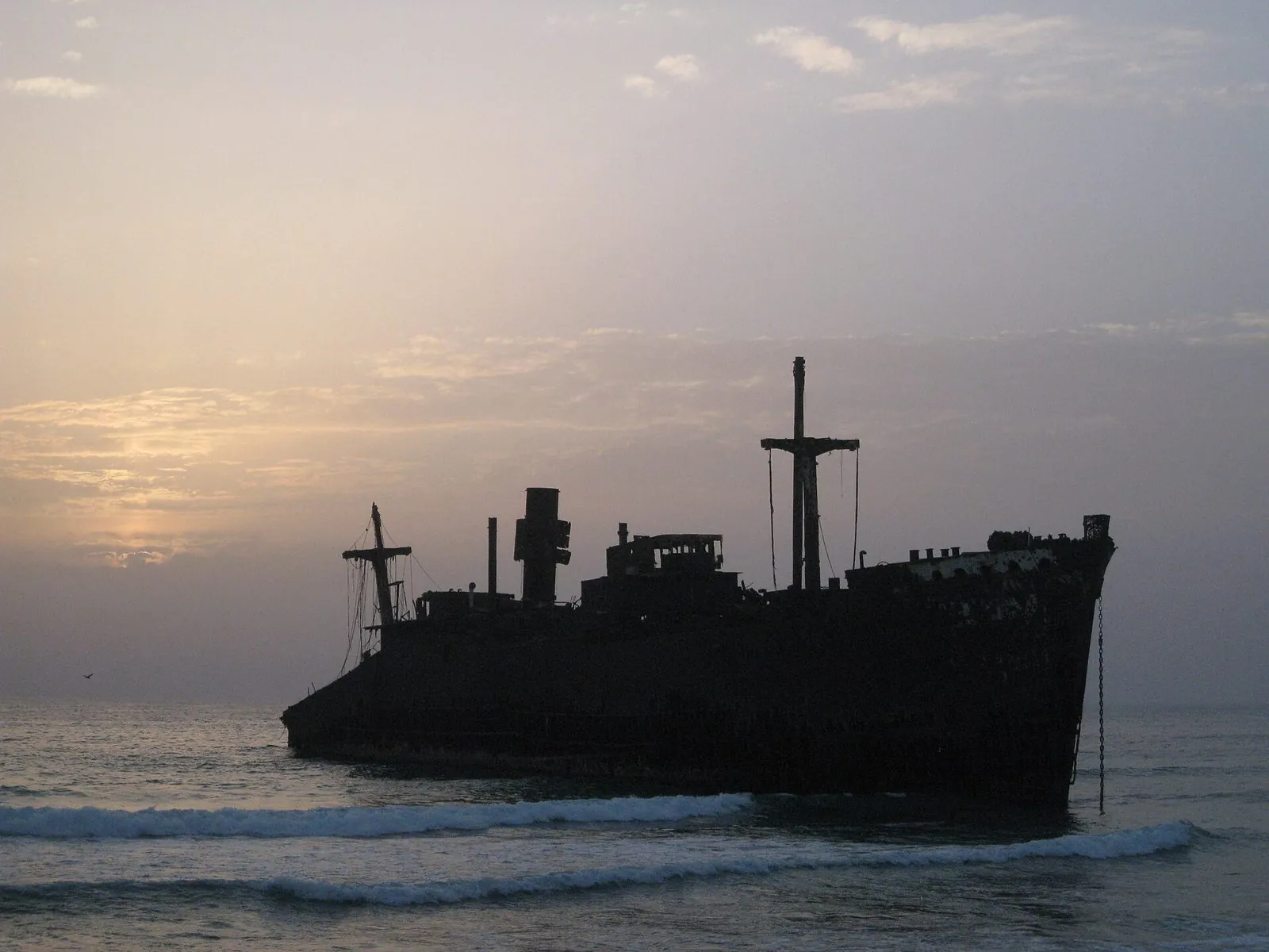 The 'Greek Ship' — the rusted hull of the Greek freighter Koula F, beached on Kish Island in 1966 and now silhouetted at every sunset against the Persian Gulf.