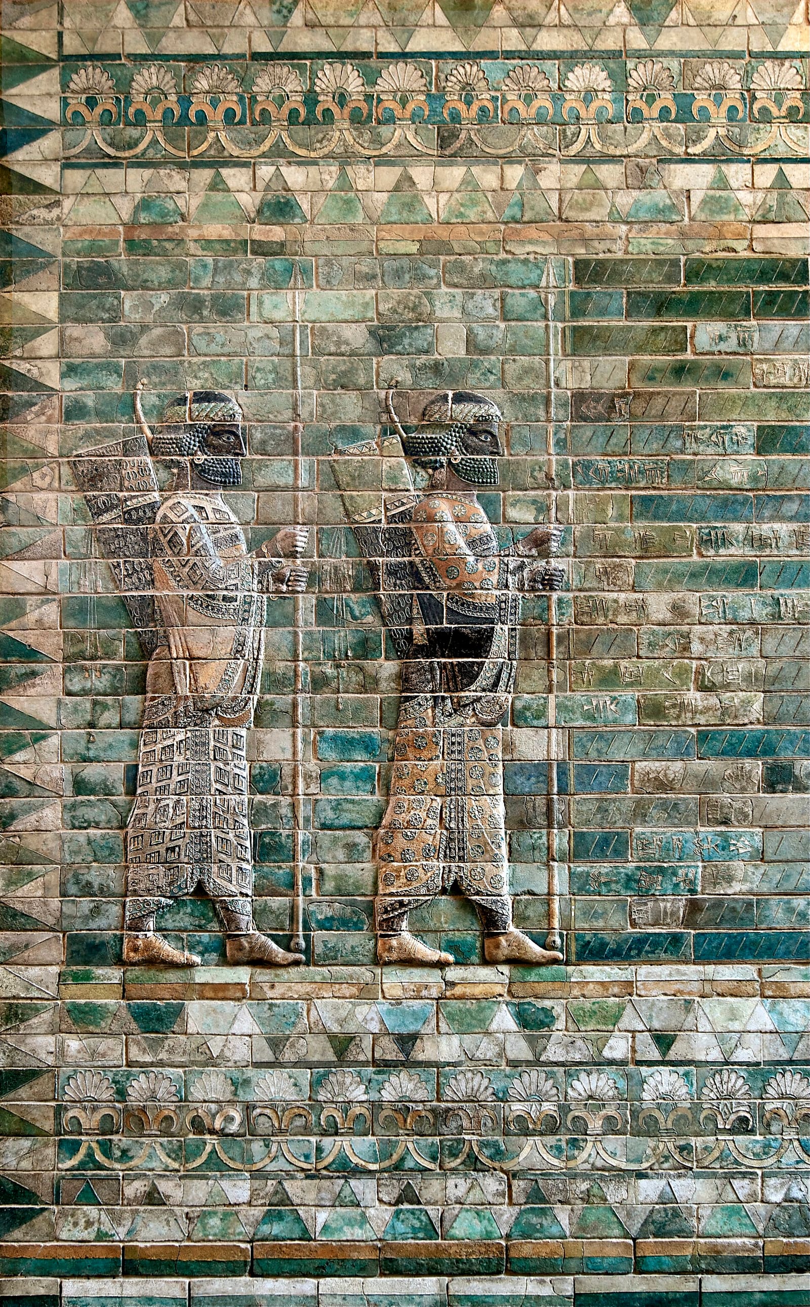 A polychrome glazed brick relief of a Persian Immortal soldier, circa 510 BCE, from the palace of Darius I in Susa, holding a spear and wearing elaborate robes.