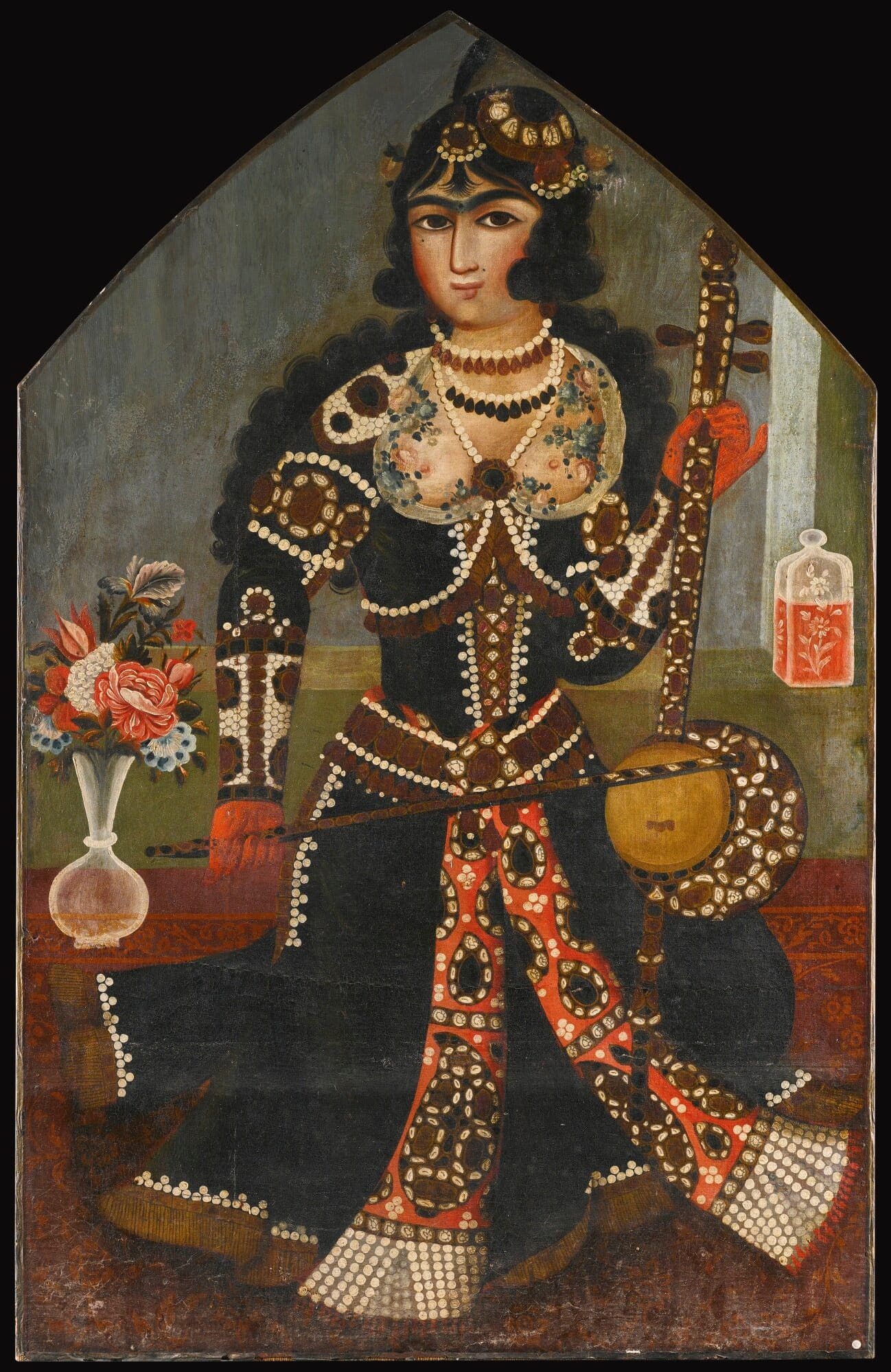 A photograph of an Iranian musician playing the Kamancheh, a traditional bowed spike fiddle, held upright on the knee.