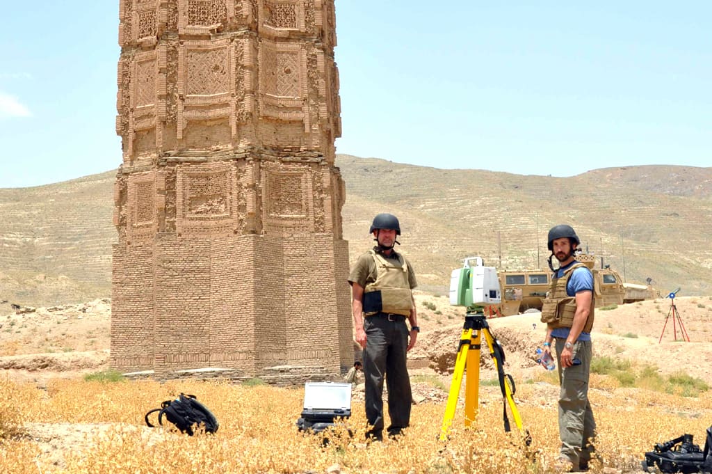 Two towering 12th-century minarets made of baked brick in Ghazni, Afghanistan, decorated with intricate terracotta Kufic and Naskhi calligraphy, remnants of the city's imperial glory.